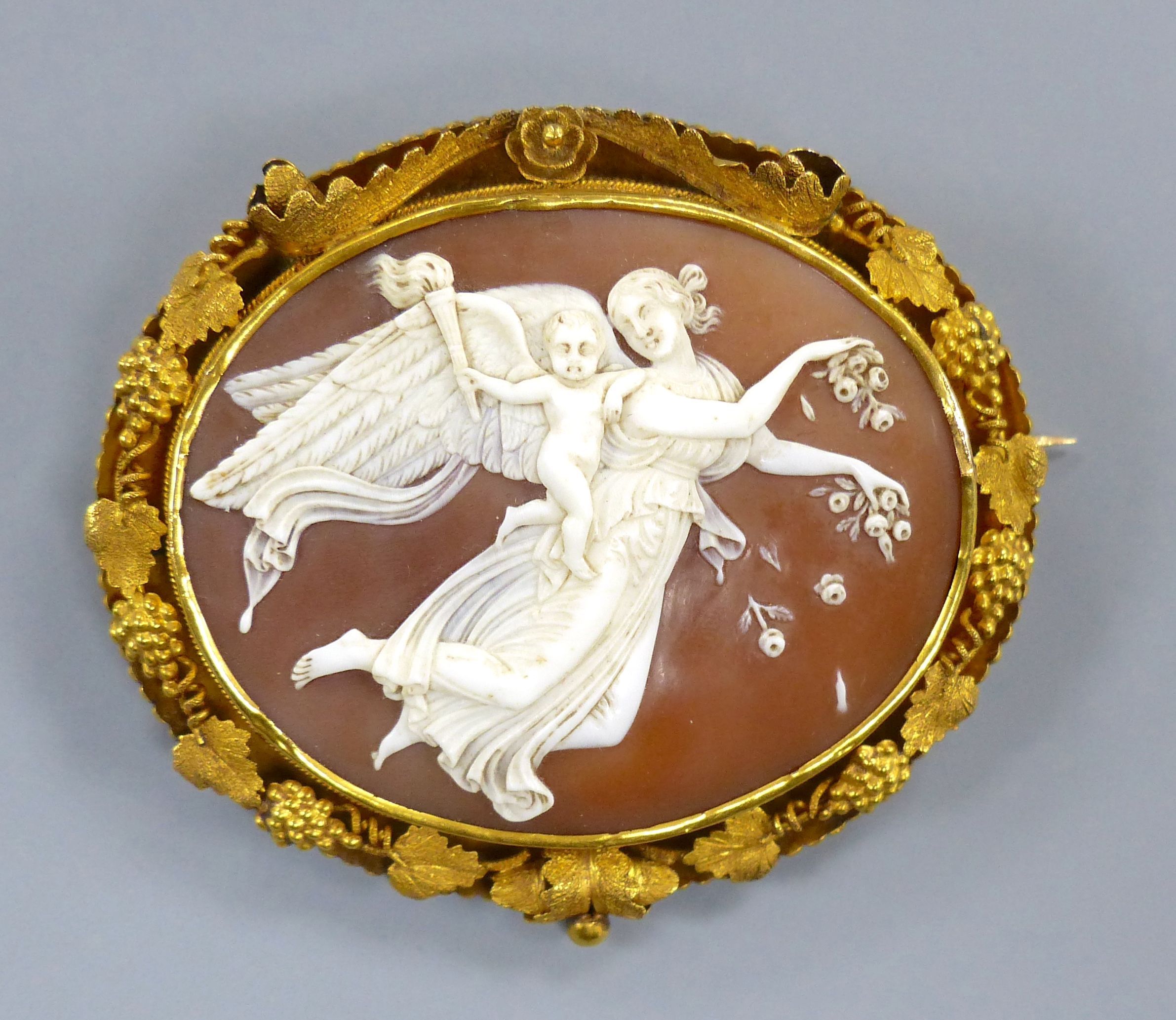 A Victorian pinchbeck and cameo shell brooch.